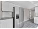 Kitchen with stainless steel refrigerator, white cabinets and gray countertops at 8308 N Mulberry St, Tampa, FL 33604