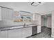 Bright kitchen with stainless steel appliances, white cabinets, and modern countertops at 8308 N Mulberry St, Tampa, FL 33604