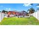 Spacious backyard featuring a screened-in pool, lush green grass, and a privacy fence for outdoor enjoyment at 8436 White Poplar Dr, Riverview, FL 33578