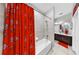 Bright bathroom with a tub/shower and a vanity; decorated with Buckeye themed accessories at 8436 White Poplar Dr, Riverview, FL 33578