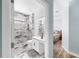 A stylish bathroom features a glass-enclosed shower with marble-look tile at 8436 White Poplar Dr, Riverview, FL 33578