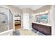 Bright bathroom featuring a double sink vanity, tile floors, and walk-in shower at 8436 White Poplar Dr, Riverview, FL 33578