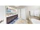 A spacious bathroom showcases a dual sink vanity, soaking tub, and a separate closet at 8436 White Poplar Dr, Riverview, FL 33578