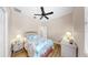 Bright bedroom with light color walls, a ceiling fan and coastal-themed bedding at 8436 White Poplar Dr, Riverview, FL 33578