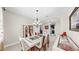 Bright dining room area featuring modern light fixture and display cabinet at 8436 White Poplar Dr, Riverview, FL 33578