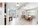 Open-concept dining area with elegant chandelier and access to the main entrance at 8436 White Poplar Dr, Riverview, FL 33578