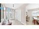 Light and bright foyer featuring decorative glass front door, tile flooring, and entry to dining room at 8436 White Poplar Dr, Riverview, FL 33578