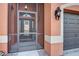 Welcoming screened entryway with glass front door, elegant sconces, and neutral stucco exterior at 8436 White Poplar Dr, Riverview, FL 33578