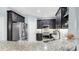 Well-equipped kitchen with stainless steel refrigerator, granite counters and tile backsplash at 8436 White Poplar Dr, Riverview, FL 33578