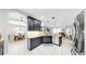 Modern kitchen featuring granite countertops, stainless steel appliances, and dark cabinetry at 8436 White Poplar Dr, Riverview, FL 33578
