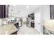 Modern kitchen with stainless steel appliances, granite countertops, and view to living areas at 8436 White Poplar Dr, Riverview, FL 33578