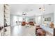 Bright living room featuring tile floors, leather furniture, and french doors to the exterior at 8436 White Poplar Dr, Riverview, FL 33578