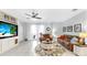 Spacious living room featuring a ceiling fan and sliding glass doors to the back patio at 8436 White Poplar Dr, Riverview, FL 33578