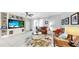Cozy living room featuring a built-in entertainment center, comfortable seating, and lots of natural light at 8436 White Poplar Dr, Riverview, FL 33578