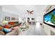Open-concept living room with tile floors, connecting to the dining and kitchen areas at 8436 White Poplar Dr, Riverview, FL 33578
