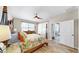 Serene main bedroom featuring wood-look floors, natural light, and a private en-suite bathroom for comfort at 8436 White Poplar Dr, Riverview, FL 33578