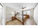 Bright main bedroom featuring wood-look floors, a ceiling fan, and a dresser for a serene and restful space at 8436 White Poplar Dr, Riverview, FL 33578