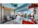 Spacious covered outdoor living area featuring a bar, seating, and a view of the pool at 8436 White Poplar Dr, Riverview, FL 33578