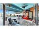 Spacious covered outdoor living area featuring a bar, seating, and a view of the pool at 8436 White Poplar Dr, Riverview, FL 33578