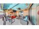 Outdoor living space with a full tiki bar setup, fun decor, and comfortable seating, perfect for relaxing and entertaining at 8436 White Poplar Dr, Riverview, FL 33578