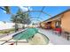 Sparkling pool in a screened enclosure featuring an outdoor bar and seating area at 8436 White Poplar Dr, Riverview, FL 33578