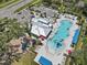 Aerial view of the community pool, playground, clubhouse, and parking area in a desirable location at 8436 White Poplar Dr, Riverview, FL 33578