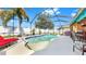 Large screened-in pool with plenty of seating and a view of the backyard at 8436 White Poplar Dr, Riverview, FL 33578