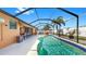 Large screened-in pool with an outdoor bar, seating, and a view of the backyard at 8436 White Poplar Dr, Riverview, FL 33578