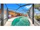 Large screened-in pool with plenty of seating and an outdoor kitchen area at 8436 White Poplar Dr, Riverview, FL 33578