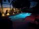The secluded pool is softly lit for evening swims and relaxation at 8436 White Poplar Dr, Riverview, FL 33578