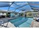 Screened pool and deck area with outdoor grill and views of the home's exterior at 8611 Parkway Cir, Riverview, FL 33569