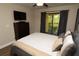 Comfortable bedroom featuring balcony access, ceiling fan, tv, and dark wood dresser at 8642 Mallard Reserve Dr # 203, Tampa, FL 33614