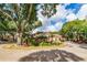 Beautifully landscaped roundabout leading to a luxurious clubhouse and lush greenery surrounding the area at 8642 Mallard Reserve Dr # 203, Tampa, FL 33614
