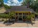 Elegant clubhouse with large windows, brick columns, and lush landscaping at 8642 Mallard Reserve Dr # 203, Tampa, FL 33614