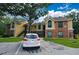 Exterior of tan and brick condo complex featuring car parking with assigned numbered spaces at 8642 Mallard Reserve Dr # 203, Tampa, FL 33614