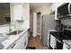 Updated kitchen featuring white cabinets, stainless steel appliances, and a pantry at 8642 Mallard Reserve Dr # 203, Tampa, FL 33614