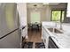 Bright kitchen featuring granite countertops, stainless steel appliances, and a sunlit dining area at 8642 Mallard Reserve Dr # 203, Tampa, FL 33614