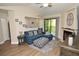 Inviting living room featuring a fireplace, balcony access, and an open-concept design at 8642 Mallard Reserve Dr # 203, Tampa, FL 33614