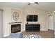 Cozy living room featuring a fireplace with stone surround and decorative wall art at 8642 Mallard Reserve Dr # 203, Tampa, FL 33614
