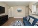 Bright living room featuring neutral walls, a blue sectional sofa, and hardwood floors throughout at 8642 Mallard Reserve Dr # 203, Tampa, FL 33614