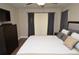 Comfortable bedroom with a ceiling fan, neutral color palette, and hardwood floors at 8642 Mallard Reserve Dr # 203, Tampa, FL 33614