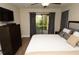 Bright bedroom with balcony, neutral color palette, and hardwood floors at 8642 Mallard Reserve Dr # 203, Tampa, FL 33614