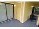 A charming patio with yellow siding, a gray deck, a door, and outdoor seating at 8642 Mallard Reserve Dr # 203, Tampa, FL 33614