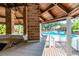 Beautiful poolside bar featuring brick columns, white tiling, and a wooden roof structure for entertaining guests at 8642 Mallard Reserve Dr # 203, Tampa, FL 33614