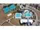 Aerial view of the community amenities, including swimming pools, tennis courts, and sand volleyball at 8765 Sentiero Dr, Land O Lakes, FL 34637