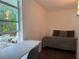 Comfortable bedroom featuring a desk, chair, and a serene outdoor view at 907 Fruitland Ave, Bradenton, FL 34207