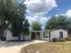 An inviting single-story home with a curved driveway and tropical landscaping for a warm, welcoming appearance at 907 Fruitland Ave, Bradenton, FL 34207