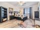 Cozy bedroom featuring a ceiling fan, stylish decor, and a comfortable bed with unique patterned bedding at 9588 Ibis Grove Blvd, Wesley Chapel, FL 33545