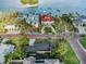 Panoramic aerial image capturing stunning waterfront properties, manicured lawns, and swaying palm trees at 100 Buena Vista S Dr, Dunedin, FL 34698