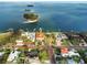 Stunning aerial view of waterfront homes with boat docks surrounded by clear blue water and lush tropical landscaping at 100 Buena Vista S Dr, Dunedin, FL 34698